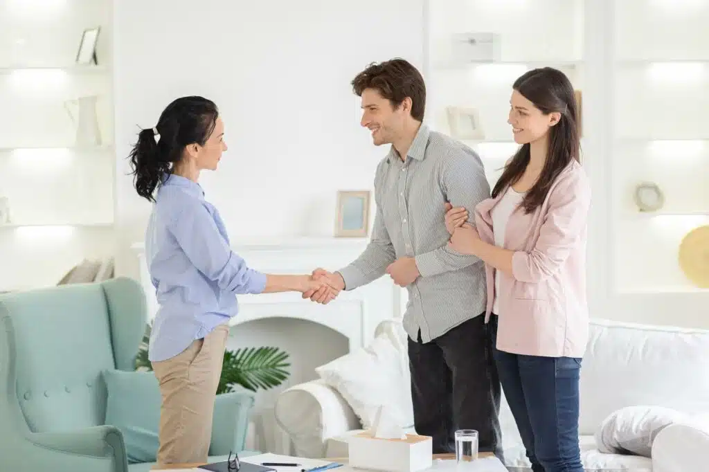 Psychologist And Thankful Couple Handshaking In Office 1